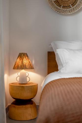 a bedroom with a bed and a lamp on a table at 3-bedrooms Villa 5min from Orient Bay in Cul de Sac