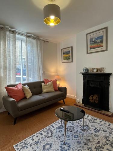 a living room with a couch and a fireplace at Traditional home perfect escape in the cotswolds in Chipping Norton