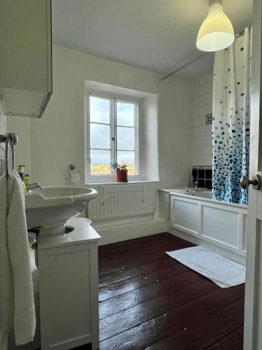 a white bathroom with a sink and a window at Traditional home perfect escape in the cotswolds in Chipping Norton