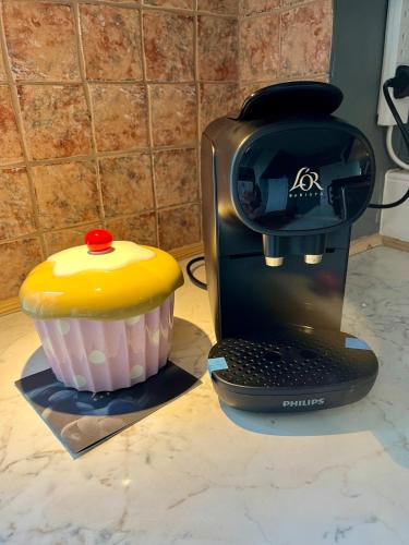 a cupcake is sitting next to a printer at Traditional home perfect escape in the cotswolds in Chipping Norton