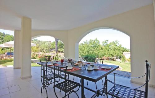 a dining room with a table and chairs on a patio at Villa Don Agostino in Vallo della Lucania