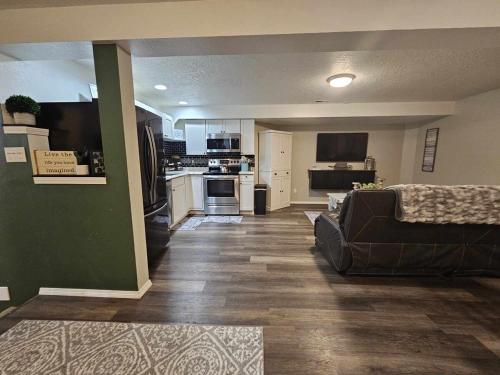 a living room with a couch and a kitchen at Centrally Located 1500 SqFt Private Guest Suite with Hot Tub in Meridian