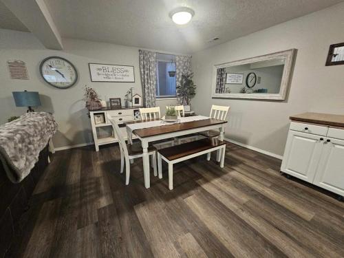 a dining room with a table and chairs and a bed at Centrally Located 1500 SqFt Private Guest Suite with Hot Tub in Meridian