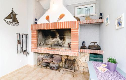 a brick fireplace in a living room with at Two-Bedroom Apartment In Ratac in Orasac