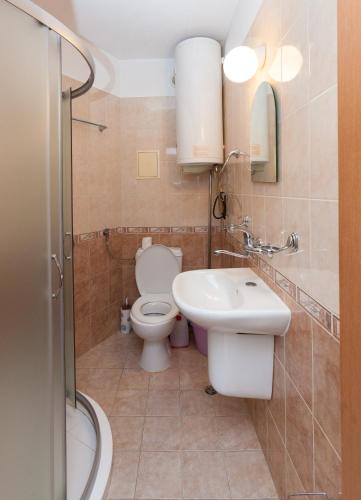 a bathroom with a toilet and a sink at Apartment Lermontov in Burgas