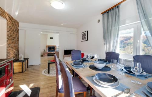 a dining room with a wooden table and blue chairs at Awesome Home In Pregrada With Wi-Fi in Pregrada