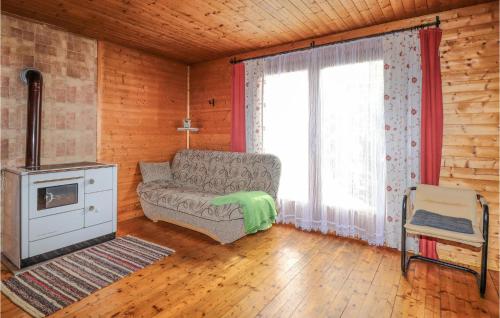 a living room with a couch and a stove at 1 Bedroom Nice Home In Neumarkt in Mühlen