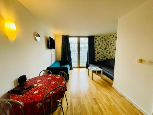 a living room with a table and a couch at Luxury 1 bed flat at WembleyPark in London