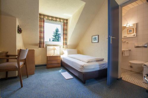 Postel nebo postele na pokoji v ubytování Hotel Wilhelmshöhe Auderath