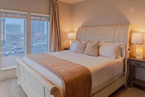 a bedroom with a large bed with a large window at Capital Views 2BR 2BA Pool,Gym,Convention Centre in Salt Lake City