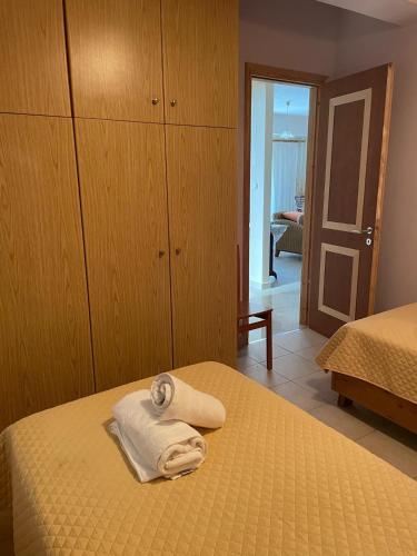 a bedroom with a bed with two towels on it at Rodopi Apartment in Skala Kefalonias