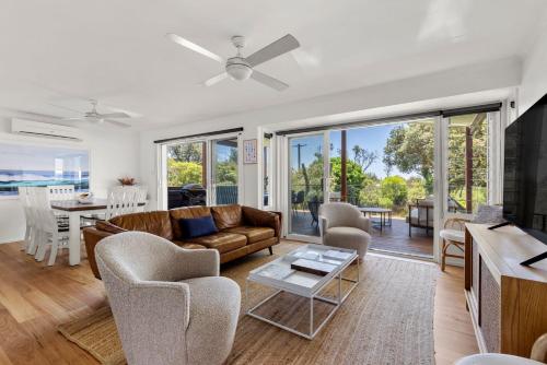 a living room with a couch and chairs and a table at Surfspray I Pet Friendly I Absolute Beachfront in Culburra Beach