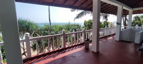 a balcony of a house with a view of the ocean at Haus am Meer "Wilde Ananas" in Koggala