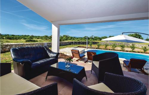 a patio with a couch and chairs and a pool at Holiday Home Drinovci With A Fireplace 444 in Drinovci