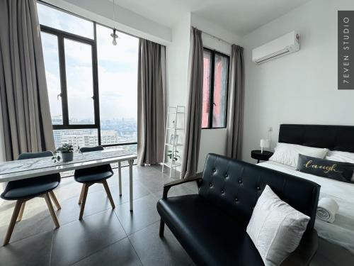 a bedroom with a couch and a table and a bed at Seven Studio - Empire Damansara - Netflix & WiFi in Petaling Jaya