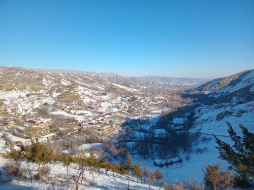 a view of a town in the snow at Spring Family Guest House in Tersak
