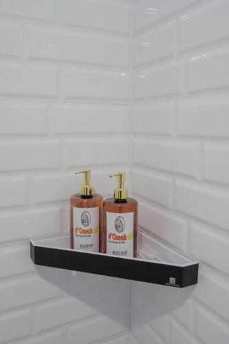 two bottles of soap on a shelf in a bathroom at d' Omah Afi 1 in Jarakan