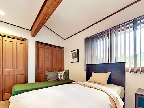 Una cama o camas en una habitación de シアトルハウス