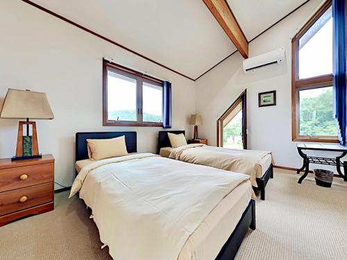 Una cama o camas en una habitación de シアトルハウス