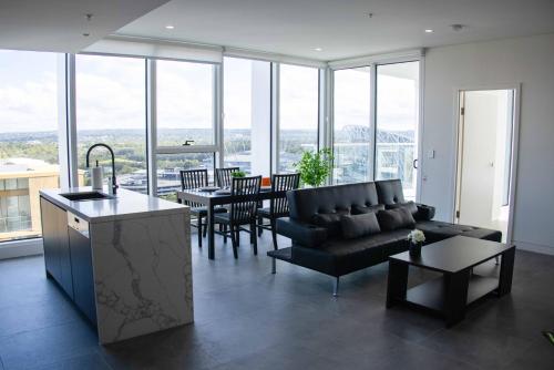 a living room with a couch and a table at Starlight Concert Stay in Sydney