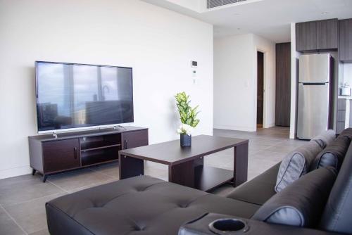 a living room with a couch and a table at Starlight Concert Stay in Sydney