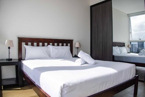 a bedroom with two large beds with white sheets at Starlight Concert Stay in Sydney