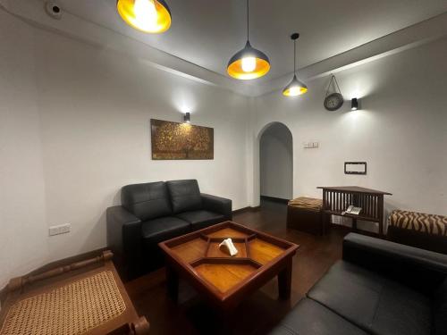 a living room with a couch and a table at Serenity Lake Nuwara Eliya in Nuwara Eliya