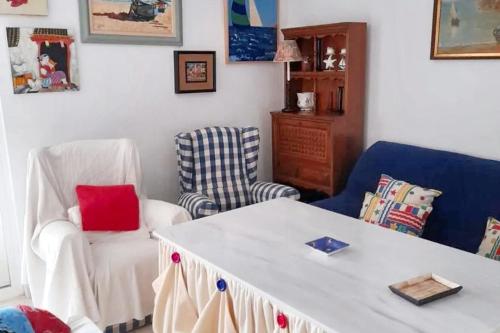 a living room with two chairs and a table at Charming apartment in El Rompido with sea view in El Rompido