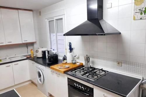 a kitchen with a stove top oven next to a sink at Charming apartment in El Rompido with sea view in El Rompido