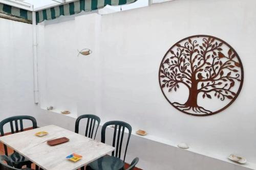 a dining room with a tree mural on the wall at Charming apartment in El Rompido with sea view in El Rompido