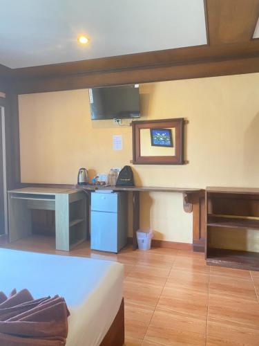 a room with a kitchen with a table and a counter at Phi Phi Treetop in Phi Phi Don