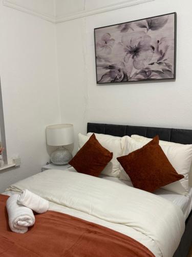 a bed with white sheets and pillows in a room at Gray Bridge Room in Northampton
