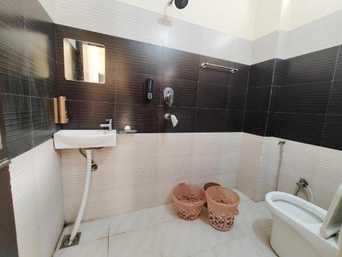 a bathroom with a sink and a toilet at Shreya's Homestay, Your Sacred Nest in Ujjain