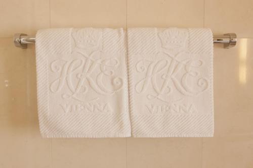 two white towels on a towel rack in a bathroom at Hotel Kaiserin Elisabeth in Vienna