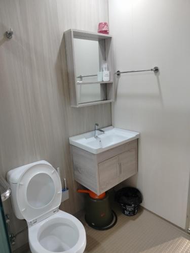 a bathroom with a white toilet and a sink at D'Leisya Studio Youth City Nilai in Nilai