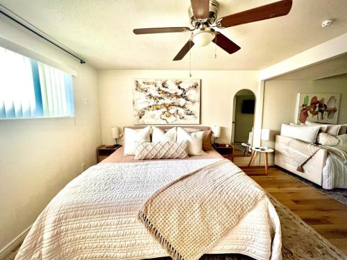 a bedroom with a bed with a ceiling fan at Family Fun! 5 King Beds-Hot Tub-Fire Pit-Ski-Hike in Sandy