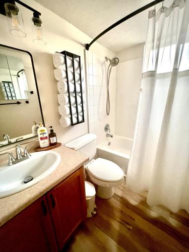 a bathroom with a sink and a toilet and a tub at Family Fun! 5 King Beds-Hot Tub-Fire Pit-Ski-Hike in Sandy