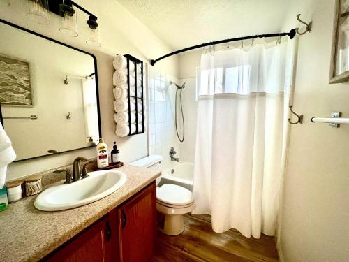 a bathroom with a sink and a shower curtain at Family Fun! 5 King Beds-Hot Tub-Fire Pit-Ski-Hike in Sandy