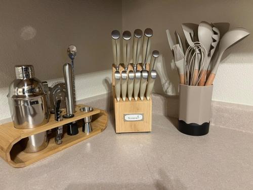 a kitchen counter with a knife block and utensils at Family Fun! 5 King Beds-Hot Tub-Fire Pit-Ski-Hike in Sandy