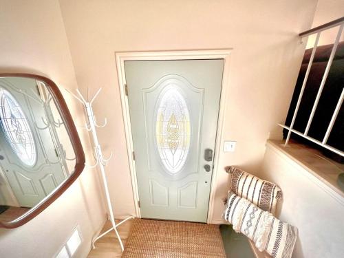 a hallway with a door with a window and a mirror at Family Fun! 5 King Beds-Hot Tub-Fire Pit-Ski-Hike in Sandy