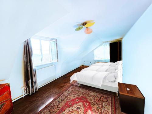 a white bedroom with a bed and a window at SARAN Guest House in Gachuurt
