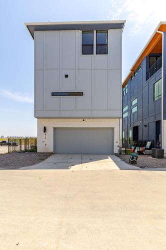 a large white building with a garage in front of it at Modern 3br Lake House In Rowlett in Rowlett