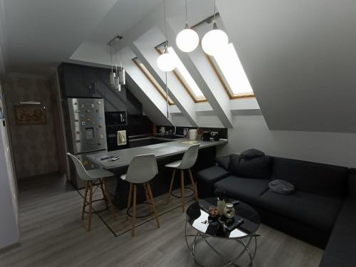 a living room with a couch and a table with chairs at Muller Premium Suite 12 Iulius Mall in Timişoara