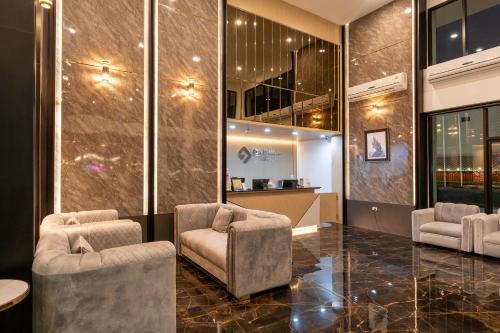 a lobby with two chairs and a table at One Sakon Nakhon Hotel in Ban Na Weng