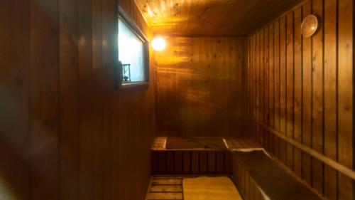 a room with a sauna with a window in it at Tabist Nisseiya Beppu Kannawa in Beppu