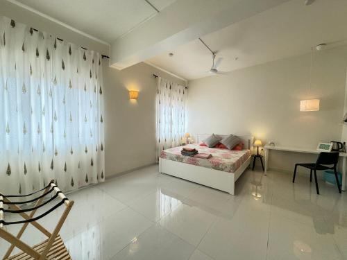 a bedroom with a bed and a desk and a chair at Soul Route in Bhubaneshwar
