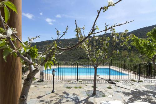 a fence with a swimming pool in the background at Casa Rural Albaida in Laroya