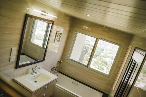 a bathroom with a sink and a mirror at Elles Residence - Serenity in Dar es Salaam