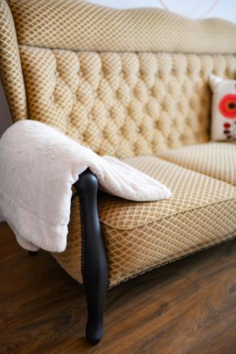 a white towel sitting on a couch with a pillow at Tweet Apartments with Sauna and optional Breakfast Close To Terme Sveti Martin in Štrigova