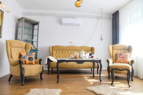 a living room with two chairs and a table at Tweet Apartments with Sauna and optional Breakfast Close To Terme Sveti Martin in Štrigova